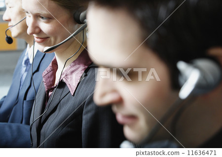 Three businesspeople talking on headsets 11636471