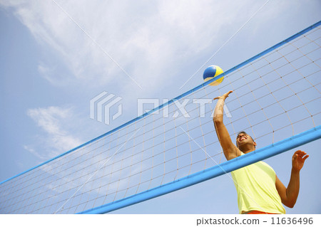 Hispanic man playing volleyball 11636496