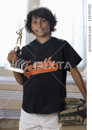 Mixed Race boy holding sports trophy 11636500