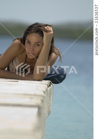 Young woman laying on dock 11636537