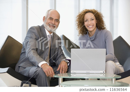 African businesspeople next to laptop 11636564