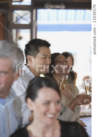 Couple drinking champagne at bar 11636570
