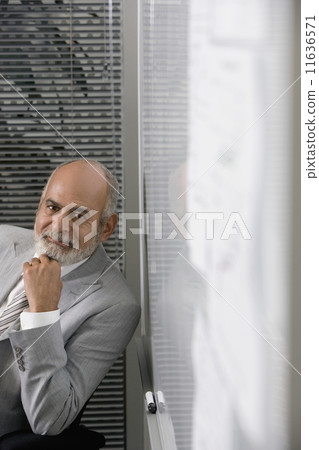 Senior African businessman next to whiteboard 11636571
