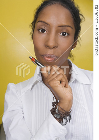 African woman holding pen African woman holding pen 11636582