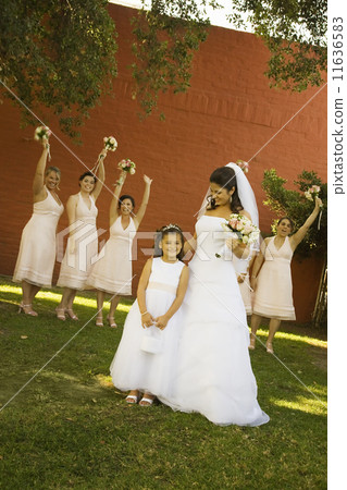 Hispanic bride and bridesmaids holding bouquets Hispanic bride and bridesmaids holding bouquets 11636583