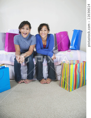 African twin sisters next to shopping bags 11636614