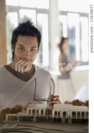 Asian male architect next to model Asian male architect next to model 11636637