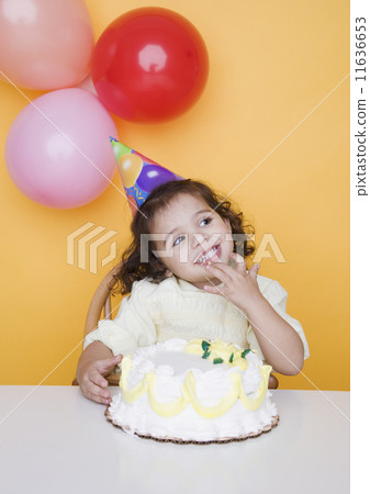Portrait of young girl with birthday cake 11636653