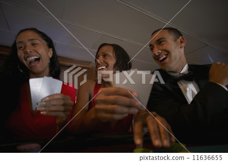 Multi-ethnic friends gambling 11636655