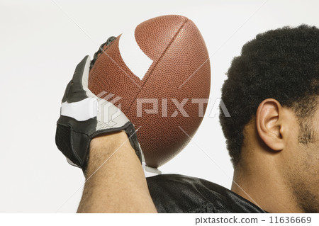 African American man holding football African American man holding football 11636669