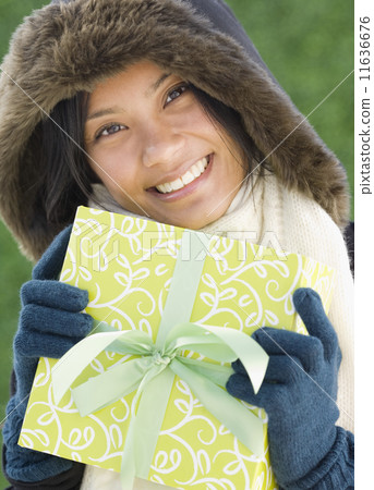 Pacific Islander woman holding gift 11636676