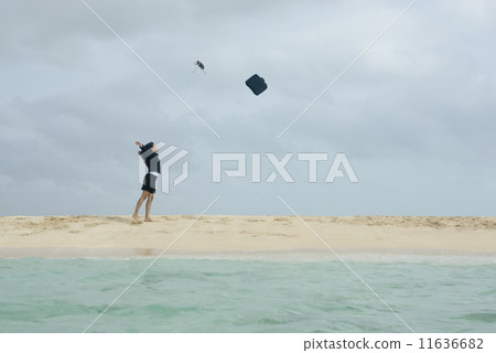 Hispanic businesswoman throwing briefcase in air Hispanic businesswoman throwing briefcase in air 11636682