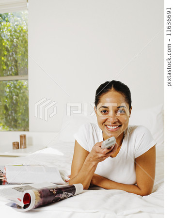 African woman holding remote control African woman holding remote control 11636691