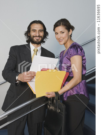Hispanic businesspeople holding folders 11636695