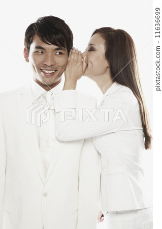 Asian woman telling secret to co-worker Asian woman telling secret to co-worker 11636699