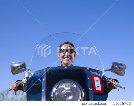 Hispanic woman sitting on motorcycle 11636708