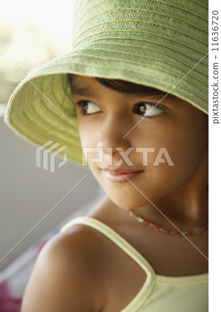 Hispanic girl wearing hat 11636720