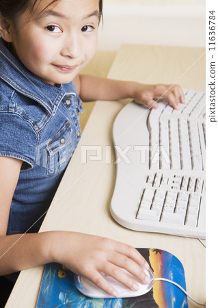 Young Asian girl using computer 11636784