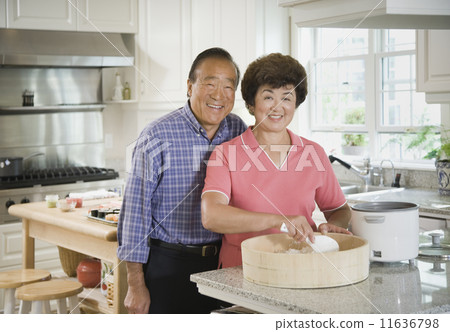 Senior Asian couple making rice Senior Asian couple making rice 11636798