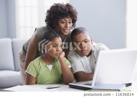 African American mother helping children with homework African American mother helping children with homework 11636814