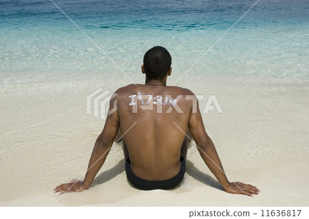 Hispanic man sitting on beach Hispanic man sitting on beach 11636817
