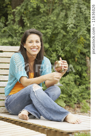 Portrait of woman holding wineglass 11636826