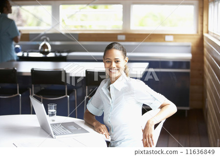 Mixed Race woman sitting with laptop Mixed Race woman sitting with laptop 11636849