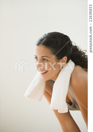 Sweating woman with a towel around her neck Sweating woman with a towel around her neck 11636853