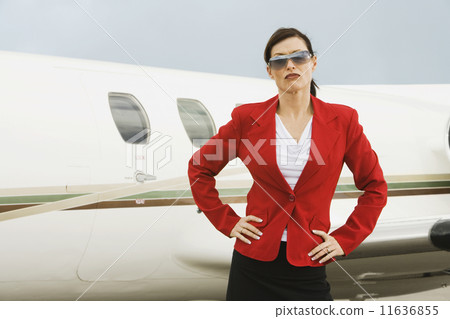 Businesswoman in front of airplane 11636855