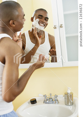 African man applying shaving cream 11636872
