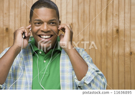 African man listening to music and smiling 11636895