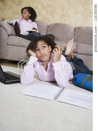 African twin sisters doing homework 11636896