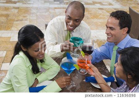 Hispanic couples toasting with cocktails 11636898