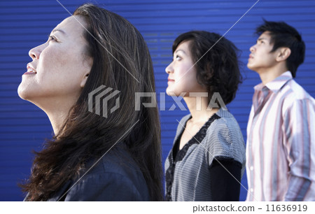 Profile of three Asian people looking up Profile of three Asian people looking up 11636919