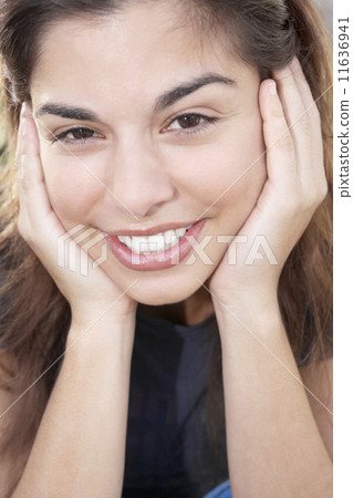 Hispanic woman resting chin on hands Hispanic woman resting chin on hands 11636941