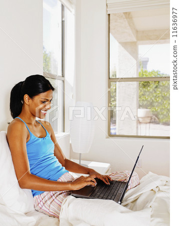 Indian woman typing on laptop 11636977