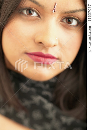 Close up of woman with jewel on forehead 11637027