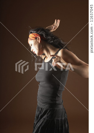 Young woman in a ruffled skirt posing for the camera 11637045