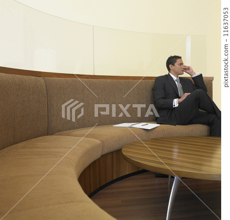Businessman sitting in waiting room Businessman sitting in waiting room 11637053