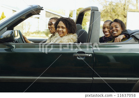 African couples driving in convertible car 11637058