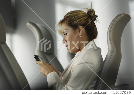 Hispanic businesswoman dialing cell phone 11637089