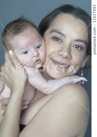 Hispanic mother hugging baby 11637095