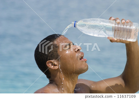 Hispanic man pouring water over head 11637109