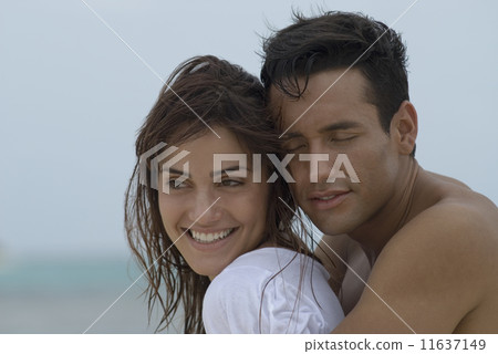 Multi-ethnic couple hugging 11637149