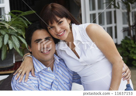 Hispanic couple hugging Hispanic couple hugging 11637153
