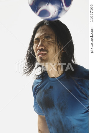 Asian male soccer player bouncing ball on head 11637166