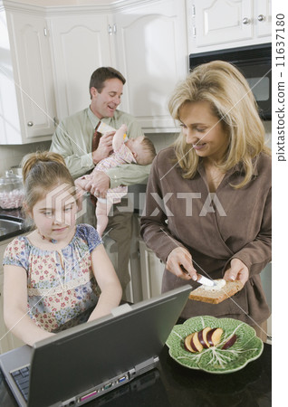 Family in kitchen at breakfast time Family in kitchen at breakfast time 11637180