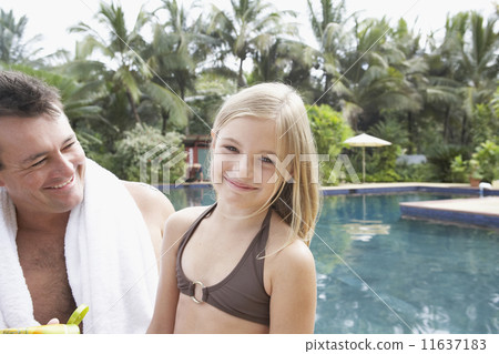 Father and daughter next to swimming pool Father and daughter next to swimming pool 11637183