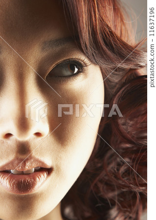 Asian woman looking sideways Asian woman looking sideways 11637196