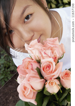 Asian woman holding flowers Asian woman holding flowers 11637198